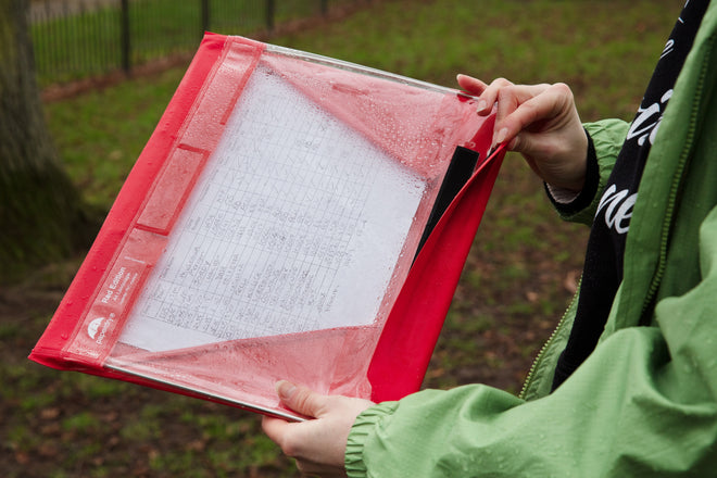 A red waterproof clipboard being used in the rain. This one is A4 landscape, fetching!